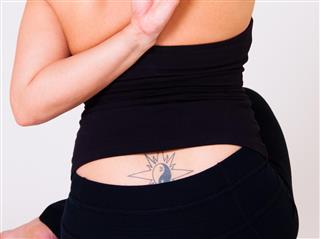 Tattooed woman in black dress