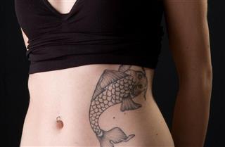 Beautiful lady with fish tattoo