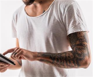 Tattooed man with tablet