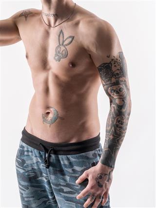Young muscular guy with tattoo