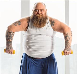 Fat man training his body