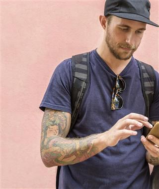 Tattooed man using phone
