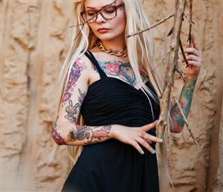 Young tattooed blonde girl