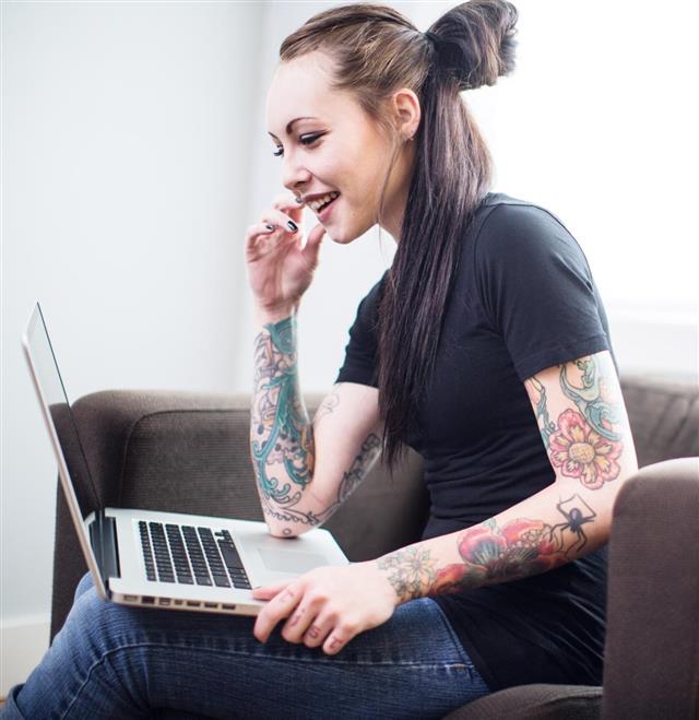 Tattooed Woman on Laptop