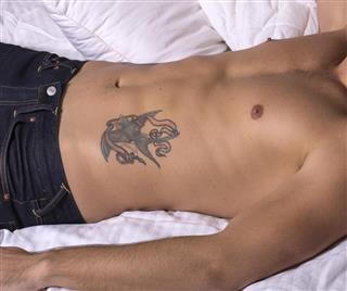 Man with tattoo on stomach