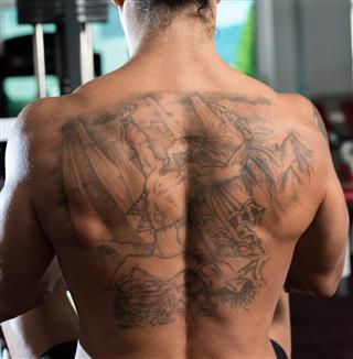 Bodybuilder with tattoo on back