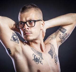Tattooed man with spectacles