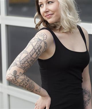 Beautiful Young Woman Arm Tattoo