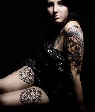 Woman With Tattoo In Black Background