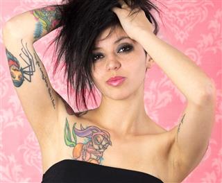 Tattooed Woman In Pink Background