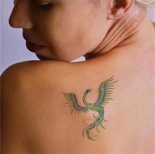 Peacock tattoo on back