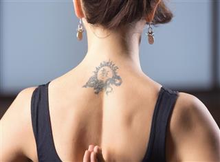 Tattoo on young woman neck