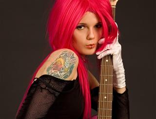 Tattooed girl with guitar