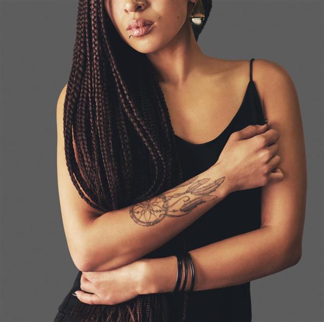 Tattooed woman with braided hair