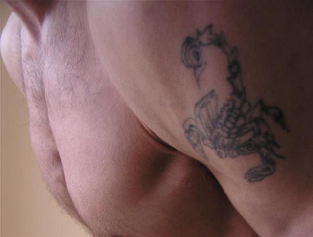 Scorpion tattoo on male arm