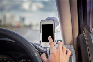 Man Driving And Using Phone