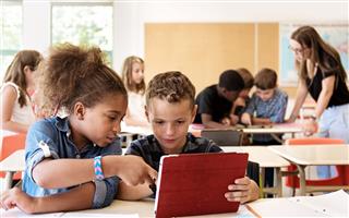 School Kids Using A Digital Tablet