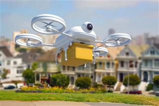 Remote Controlled Drone Delivering Package