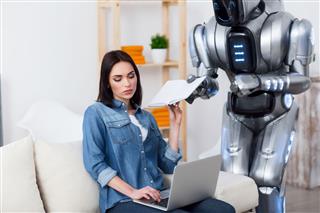 Woman Using Laptop With Robot