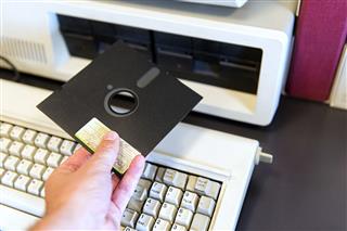 Man Inserting Floppy Disk