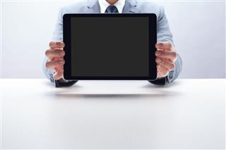 Businessman Showing Digital Tablet