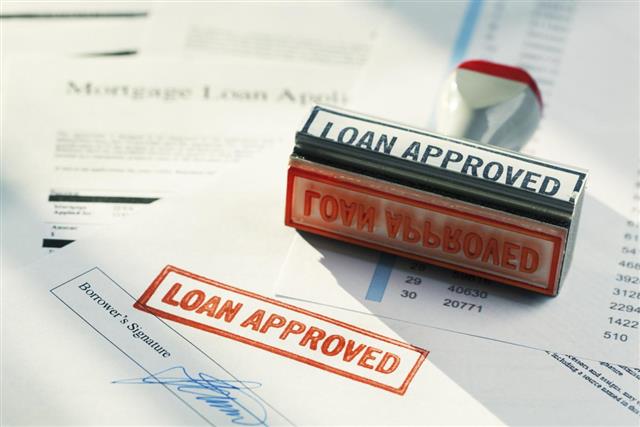 “LOAN APPROVED” Approval Red Rubber Stamp Approving Mortgage Application Document