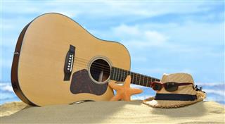 Acoustic guitar on the sandy beach