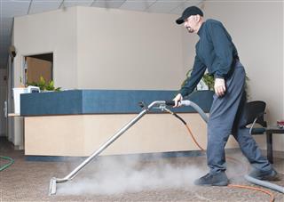 Professional Carpet Cleaner - Man Steam Cleaning