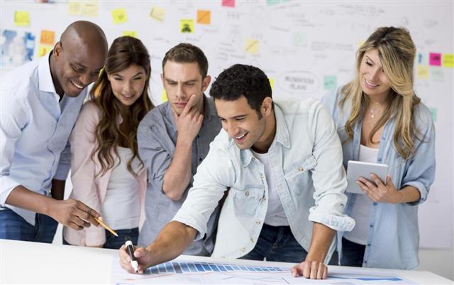 Group of people drawing a business plan