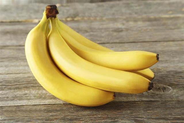 Bunch of bananas on gray wooden background