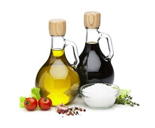 Olive oil and balsamic vinegar bottles on white backdrop