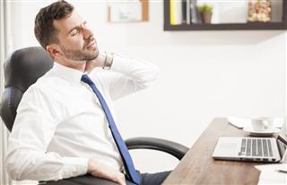 Young businessman with neck pain