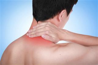Close up suffering male pain in neck on blue background