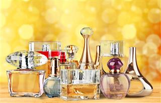 Women's perfume bottle displayed against bokeh background