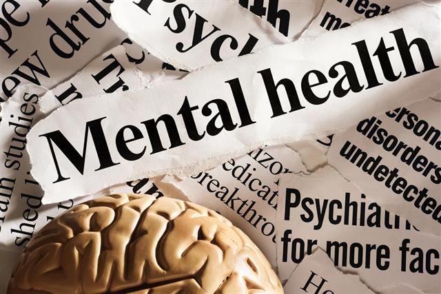 Model brain with headlines on mental health