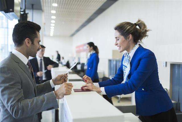 Business man in check-in counter with boarding pass