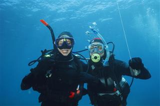 Scuba diving Underwater scene with two scuba diver in blue