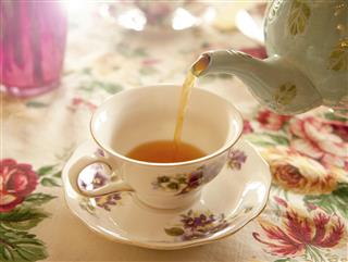 Tea party - Pouring tea into a tea cup