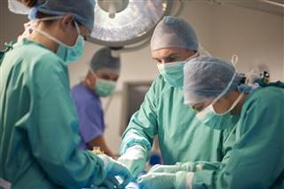 Male and female surgeon during an operation