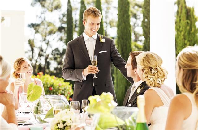 Best Man Looking At Couple While Giving Speech During Reception
