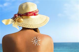 Suntan lotion woman with sunscreen solar cream