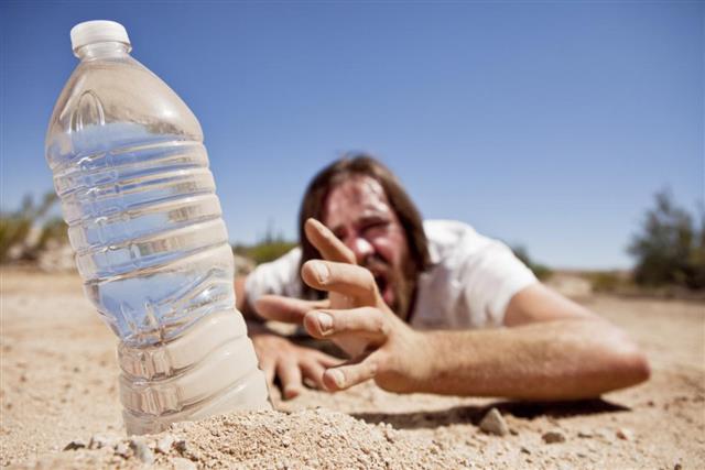 Man in Desert Reaching for Water