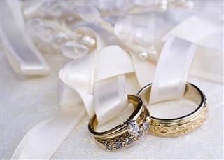 Two wedding rings tied to a pillow