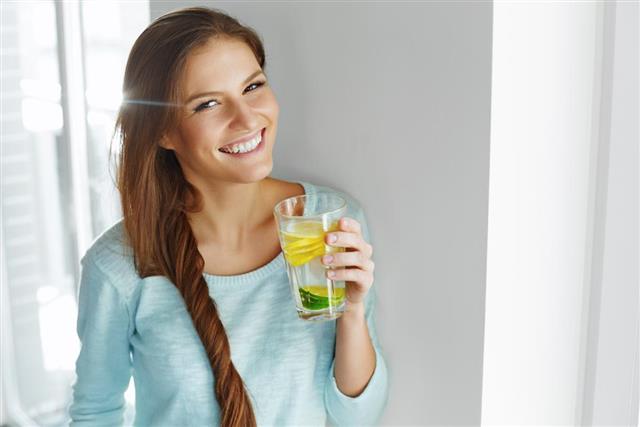 Healthy Lifestyle And Food. Woman Drinking Fruit Water. Detox