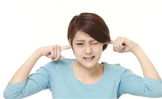 Young Japanese woman suffers from noise