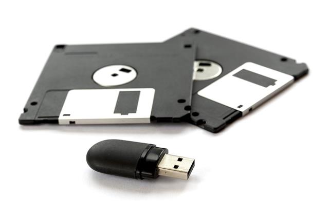 Two black floppy disks and a flash drive