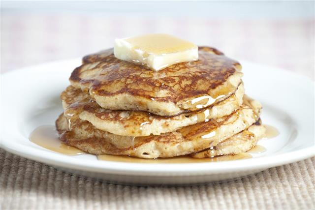 Stack of Whole Wheat Pancakes with Butter and Maple Syrup