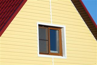 Wall covered with yellow siding