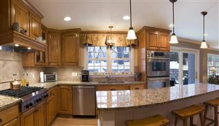 A 180 degree view of a kitchen and living area
