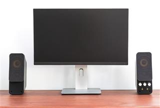Modern ips computer monitor with speaker on wooden table